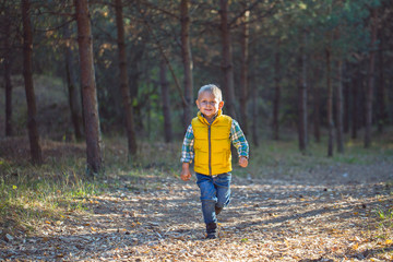 Fototapeta premium boy running along a forest path