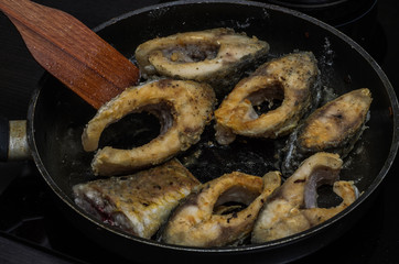 Fish carp fried in a pan