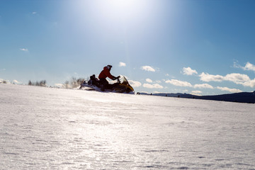 Athlete on a snowmobile.