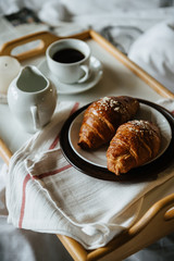 cup of coffee and croissant on table