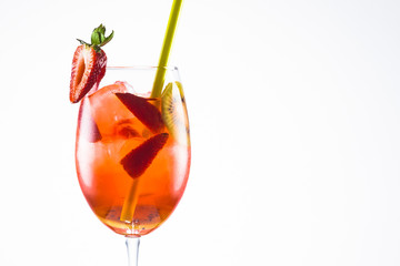 An orange alcohol cocktail with a straw on white background