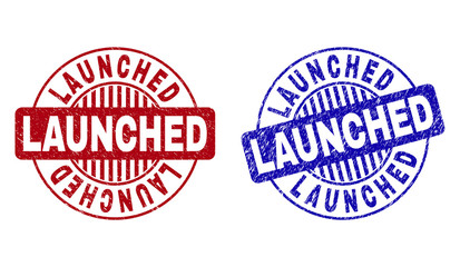 Grunge LAUNCHED round stamp seals isolated on a white background. Round seals with grunge texture in red and blue colors. Vector rubber overlay of LAUNCHED text inside circle form with stripes.