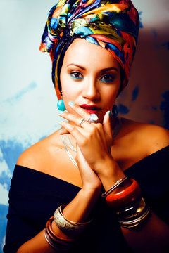 beauty bright african woman with creative make up, shawl on head like cubian closeup smiling