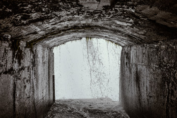 Fototapeta premium View of Niagara streams from the cave of the Journey Behind The Falls experience
