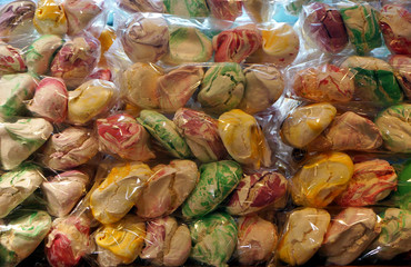 Seamless pattern of multicolored meringues. Colorful large meringue cakes. Appetizing meringues. Arrangement of cakes in several rows. View from ahead. baiser wrapped, 