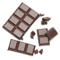 Dark organic chocolate pieces isolated on white background