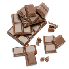 Milk organic chocolate pieces isolated on white background