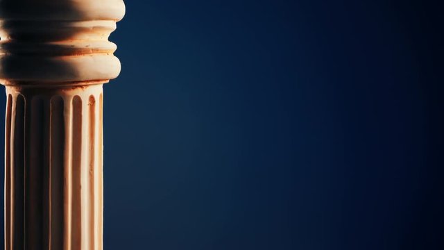 Single ancient greek column rotating slowly on color background, copy space text area