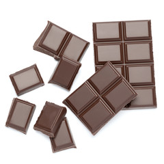 Dark organic chocolate pieces isolated on white background