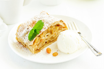 apple strudel with cinnamon and an ice cream ball.