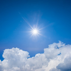 Naklejka na ściany i meble sparkle sun on a cloudy summer sky background