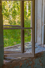 Fototapeta premium white lit vintage, old window in an ancient white brick wall in an abandoned castle, interior with light from the windows, old windows with empty frame, green grass