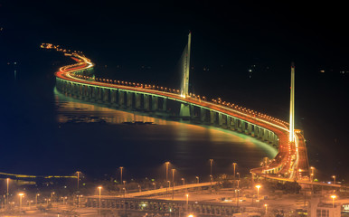 The landscape photo of night scene of the snake like bridge linking Shenzhen and Hongkong