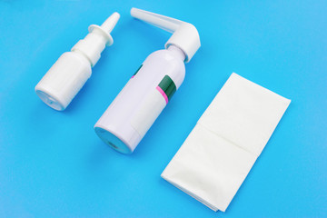 cold remedies on a blue background. Spray from a cold, spray from a sore throat, handkerchief