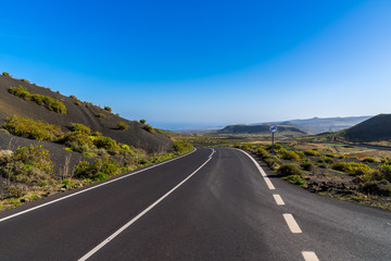 Spain, Lanzarote, Curved road through majestic beautiful volcanic nature landscape