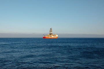 offshore oil and gas drillship, blue ocean background