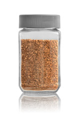 The glass jar with instant coffee in granules closed by a cover with reflection. Isolated on a white background