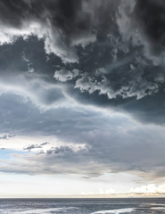 Approaching storm cloud with rain over the sea