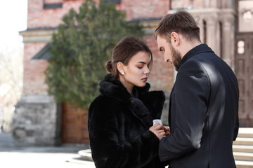 Couple pining after their relative at funeral