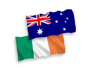 National vector fabric wave flags of Australia and Ireland isolated on white background. 1 to 2 proportion.