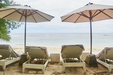 Sun beds with umbrellas on the Bali beach