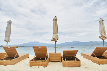 Sun beds with umbrellas on the Bali beach