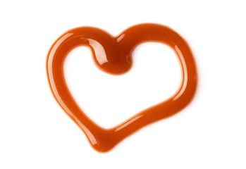 Fototapeta premium Heart made of liquid caramel on white background