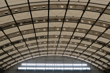 Domed roof of a modern building. Semicircular ceiling in the hangar, sports or industrial building. Copy space.