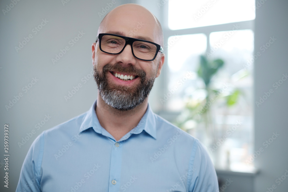 Poster Bearded middle-aged man wearing glasses.