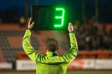 Technical referee shows 3 minutes added time during the football match.