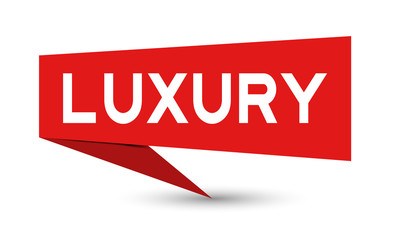 Red paper speech banner with word luxury on white background (Vector)