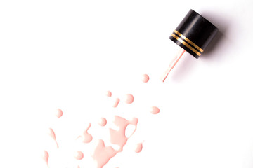 Nail polish bottle and drop on white background
