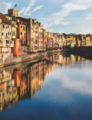 Houses in Girona reflected in the river Onyar on a summer day