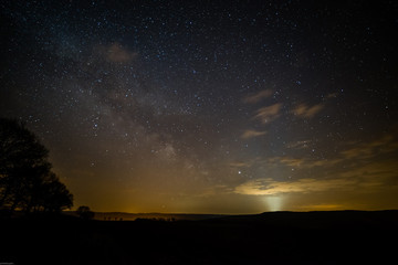 Obraz na płótnie Canvas Photographing the milkyway in Germany April 2019 with lightpollution and light beams