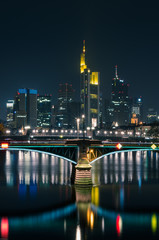 Fototapeta na wymiar Die Skyline von Frankfurt in der Nacht mit Brücke