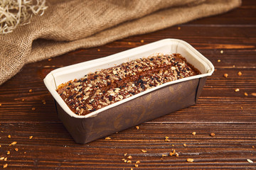 Whole wheat craft bread on wooden background. The concept of healthy food and traditional bakery. Rustic