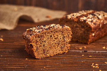 Whole wheat craft bread on wooden background. The concept of healthy food and traditional bakery. Rustic