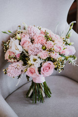 Delicate bridal bouquet with pink and beige cream flowers.