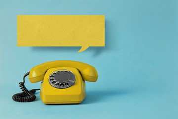 Vintage telephone with speech bubble