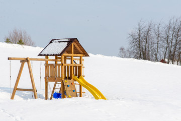 children's wooden Playground in the snow