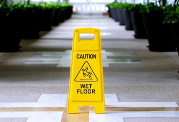 Sign showing warning of caution wet floor in the building