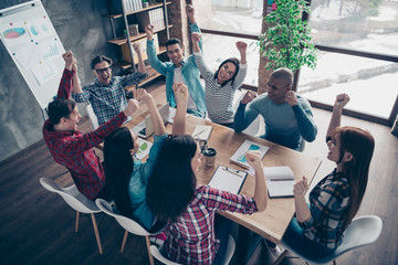 Above high angle view of attractive beautiful handsome cheerful executive managers wearing casual sitting rejoice at industrial loft interior style workplace workstation open space indoors