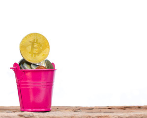 Full coins and bitcoin in pink bucket on white background