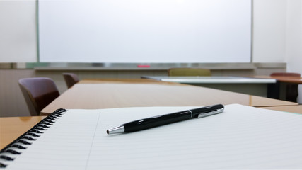 Notepad, Pen, and Glasses in Training Room. Business Meeting or Seminar Education. Classroom for Corporate Lecture or Board Meeting Presentation. Job Training and Staff Communication. Student Lecture