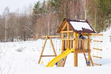 children's wooden Playground in the snow