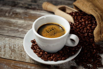 Coffee Cup And Coffee Beans On Rustic Table