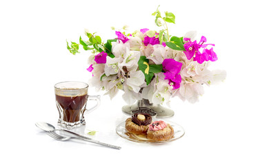 Two cakes, a bouquet of flowers and a cup of coffee