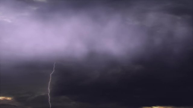 Cinematic storm clouds with lightning strikes reflecting 