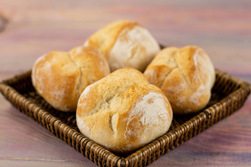 Buns in a wattled plate on a wooden background