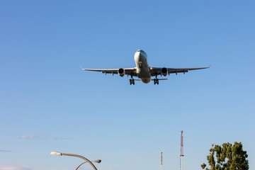 Flying passenger Airplane preparing to land